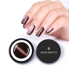 Hand with brown nail polish holding a container of 'Born Pretty' nail gel polish.