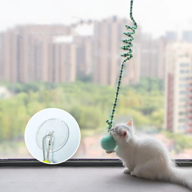 Interactive hanging cat teaser toy with bell and fluffy pom-pom ball