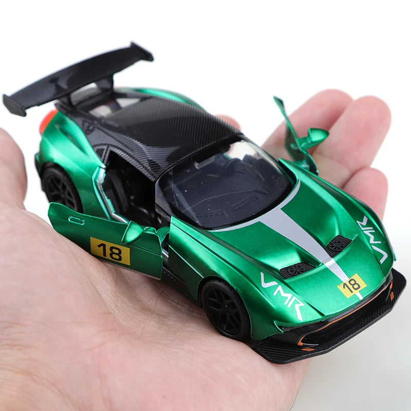 Green toy car held in a hand with a white background